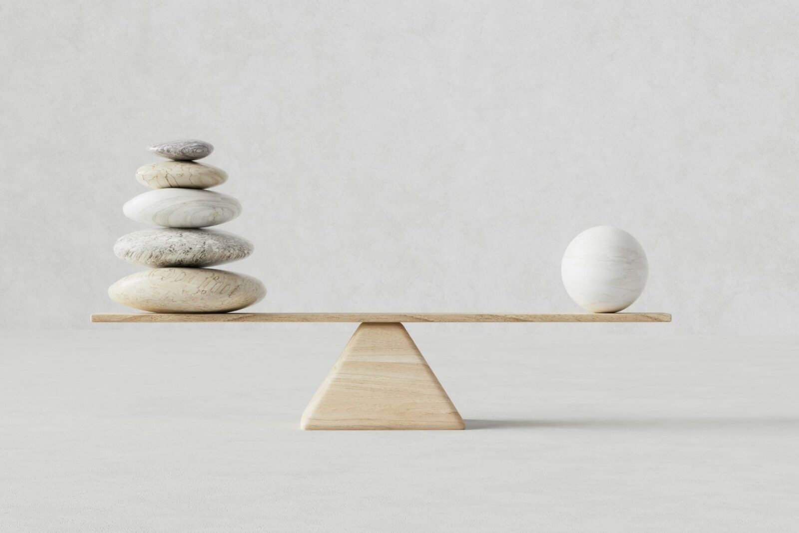 Stones and an egg balanced on a scale, the idea of a diversified portfolio