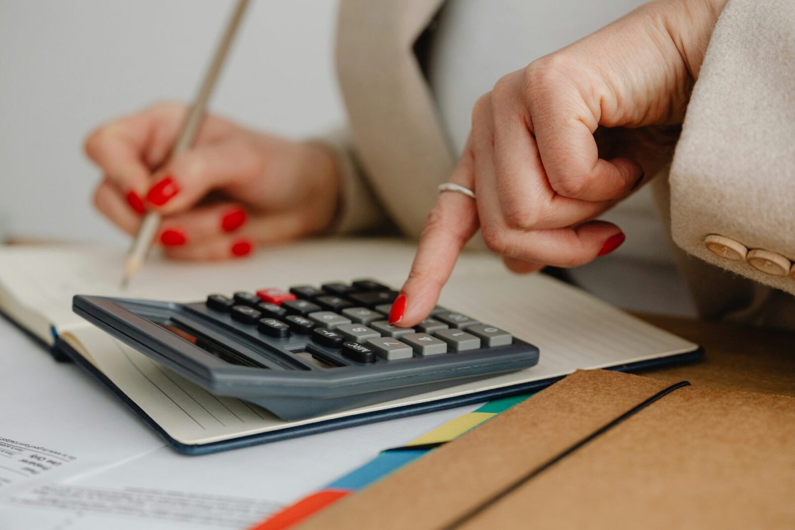 A person working through low-coupon gilt sums with a calculator