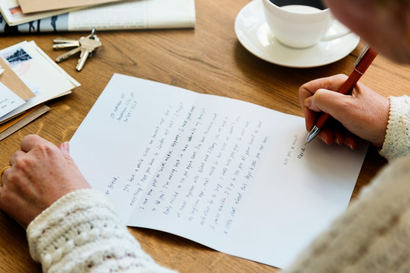 A person writing a letter, like a request to HMRC for advance assurance