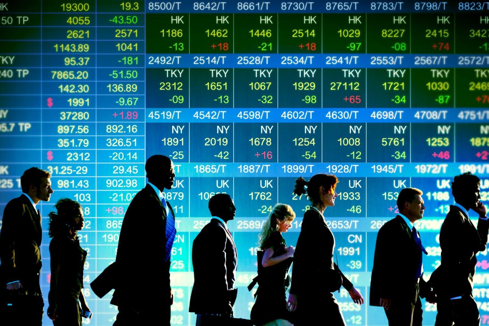 People walking past a stock market board where an ETF trades