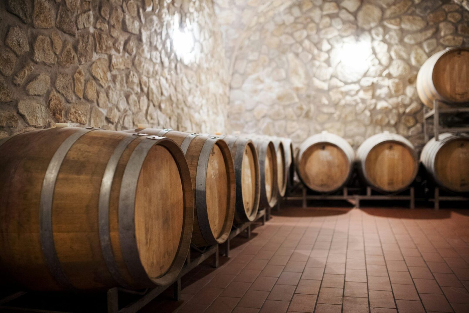 Rows of wooden casks in a cellar, the asset behind cask investment